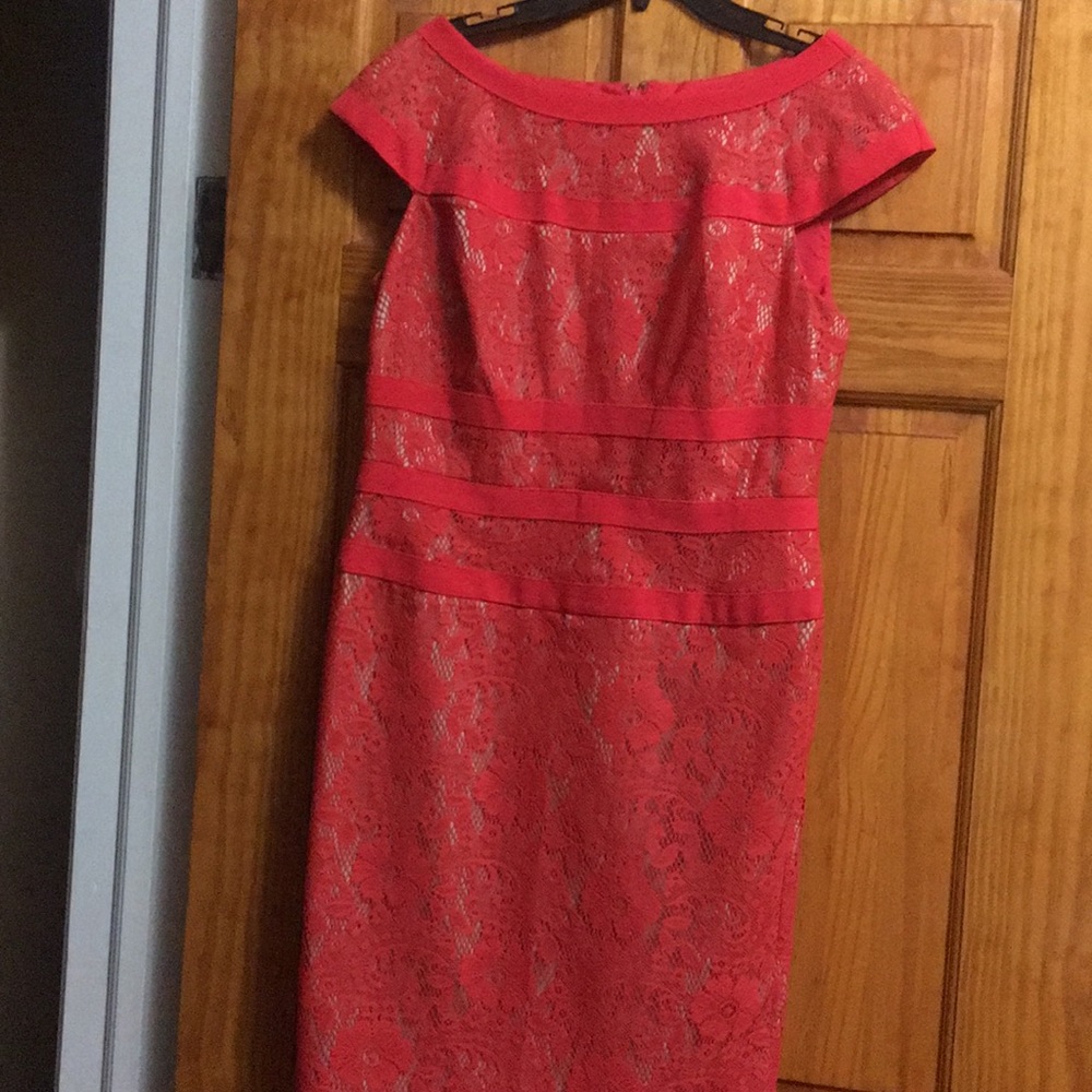 A deep coral lace with nude lining cocktail dress